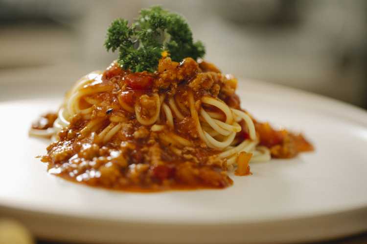 Appetizing pasta Bolognese served with parsley