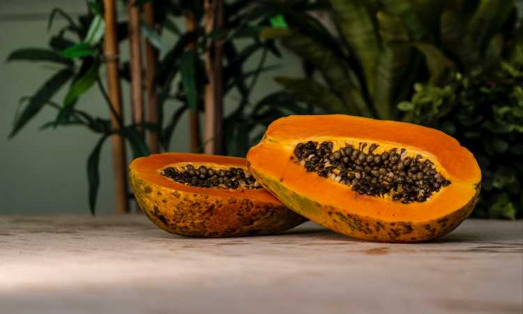 sliced papaya fruits on brown surface