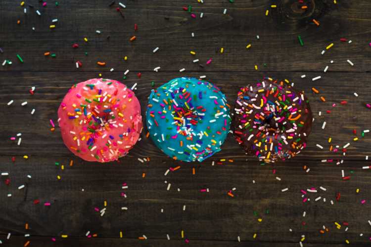 three donuts with sprinkle toppings
